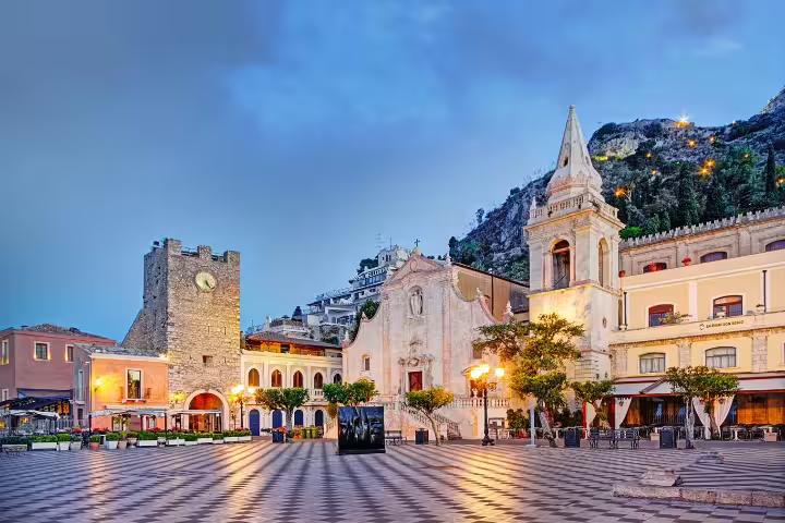 Taormina Piazza IX Aprile at sunset with church and clock tower, scenic stop on Messina port Godfather tour