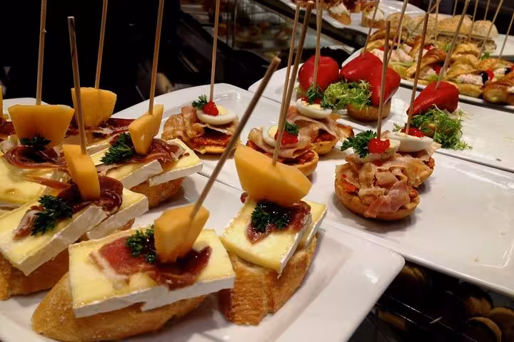 Assorted tapas with cheese and fruit skewers at Santiago Old Town tasting tour.