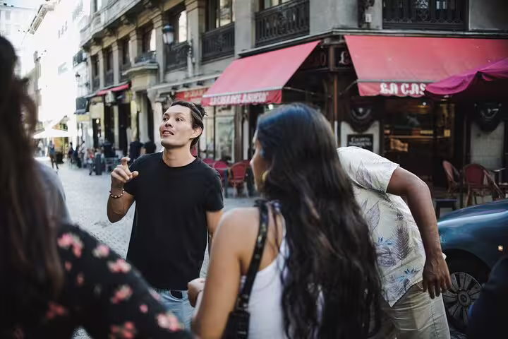 A lively guide leads a group on a Tapas Tour in Madrid, exploring vibrant streets and authentic Spanish cuisine experiences.