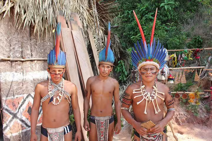 Local guides in traditional attire welcome visitors at Tapiri Rio Negro Lodge jungle tour.