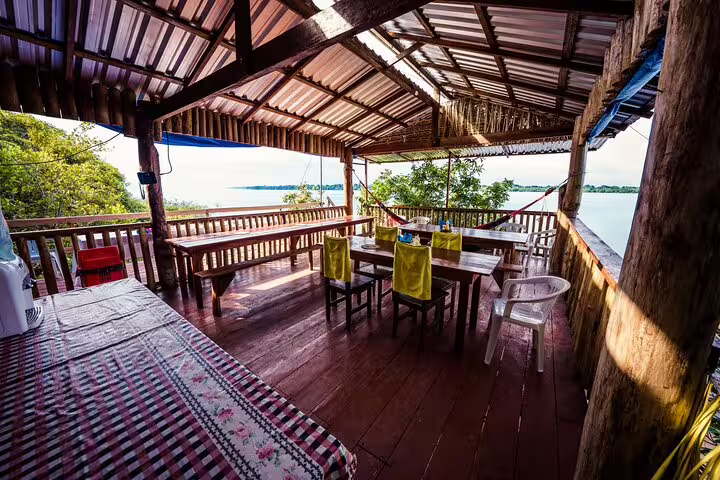 Scenic open-air dining area with river views at Tapiri Rio Negro Lodge, perfect for a serene jungle retreat experience.