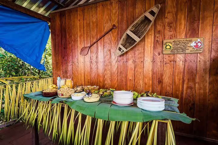 Rustic buffet setup at Tapiri Rio Negro Lodge featuring local cuisine and fresh produce for an immersive jungle dining experience.