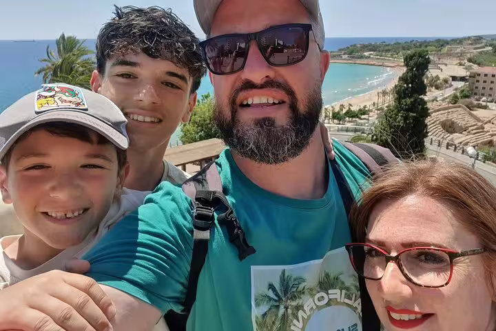 Family selfie overlooking Tarragona beach viewpoint on a self-guided scavenger hunt and sights tour