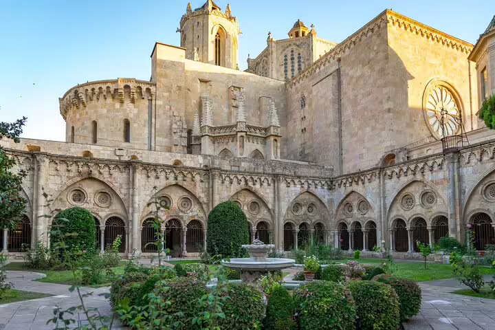 Tarragona Cathedral cloister garden and Romanesque arches on a private half-day tour from Barcelona