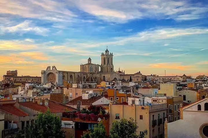 Marvel at the panoramic view of Tarragona's skyline, featuring the majestic Cathedral of Tarragona at sunset.