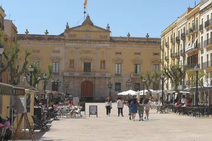Enjoy vibrant life at Plaça de la Font in Tarragona, with bustling outdoor cafes and historic architecture.