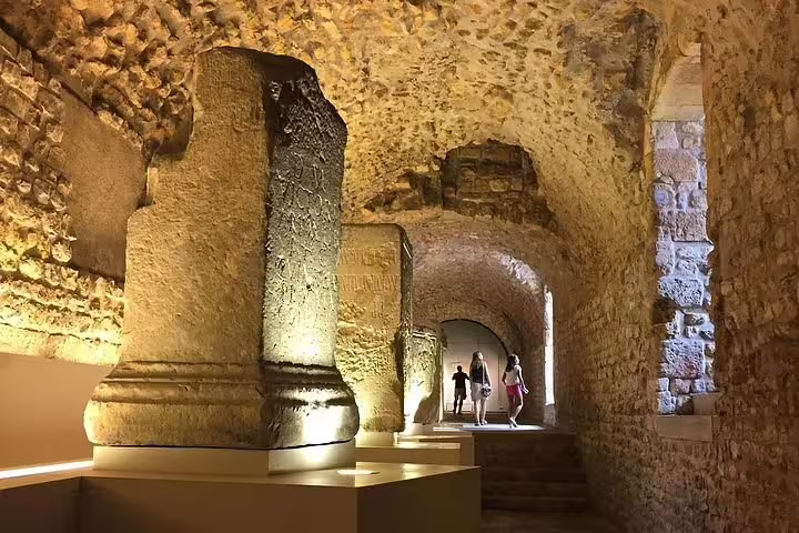 Discover the historic Roman tunnels of Tarragona, illuminated for an immersive tour experience of ancient architecture.