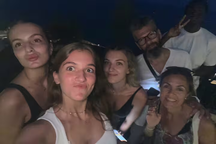 Friends taking a night selfie during a Tarragona self-guided scavenger hunt tour with mobile clues