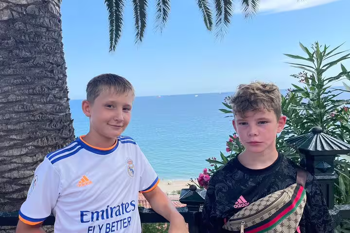 Two boys by Tarragona seafront viewpoint, perfect stop on a Tarragona scavenger hunt and sights self-guided tour