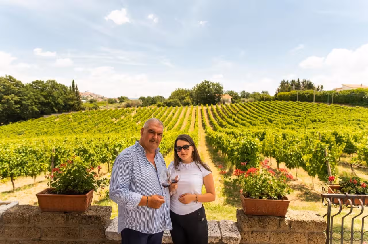Guests holding glasses in Taurasi vineyards during DOCG wine tasting and local food experience in Irpinia