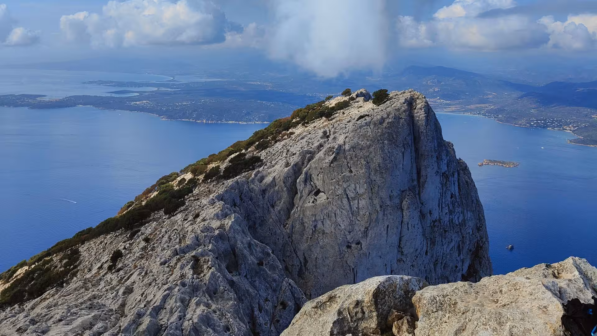 Breathtaking view from Tavolara's peak overlooking the azure waters and coastline near Porto San Paolo, Sardinia.
