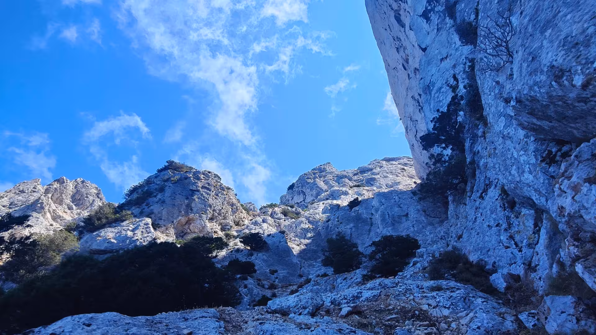 Majestic rock formations of Tavolara under a clear blue sky, ideal for climbing and trekking enthusiasts.