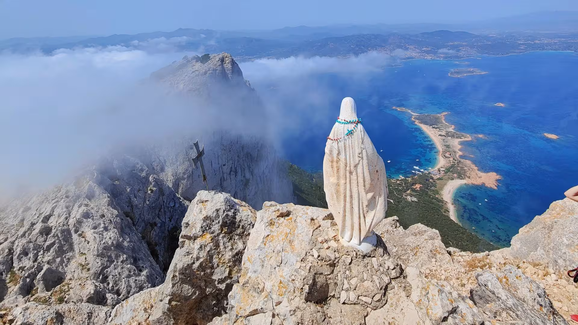 Breathtaking view from Tavolara summit, overlooking Porto San Paolo and crystal-clear Mediterranean waters.
