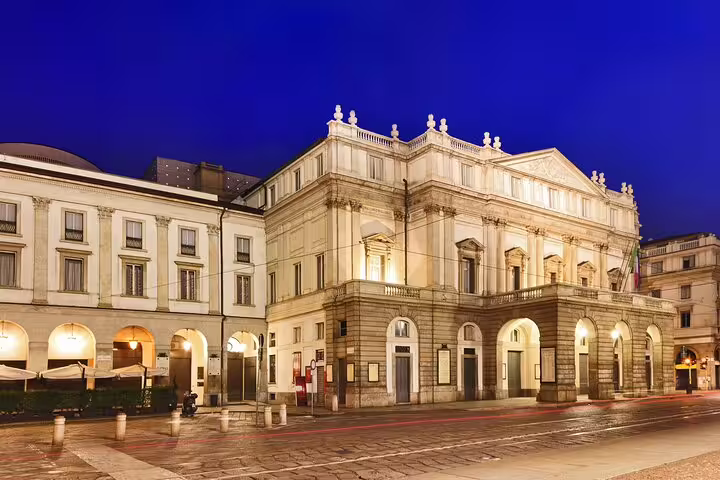 Illuminated façade of Teatro alla Scala opera house in Milan, visited on the guided private city and theatre tour