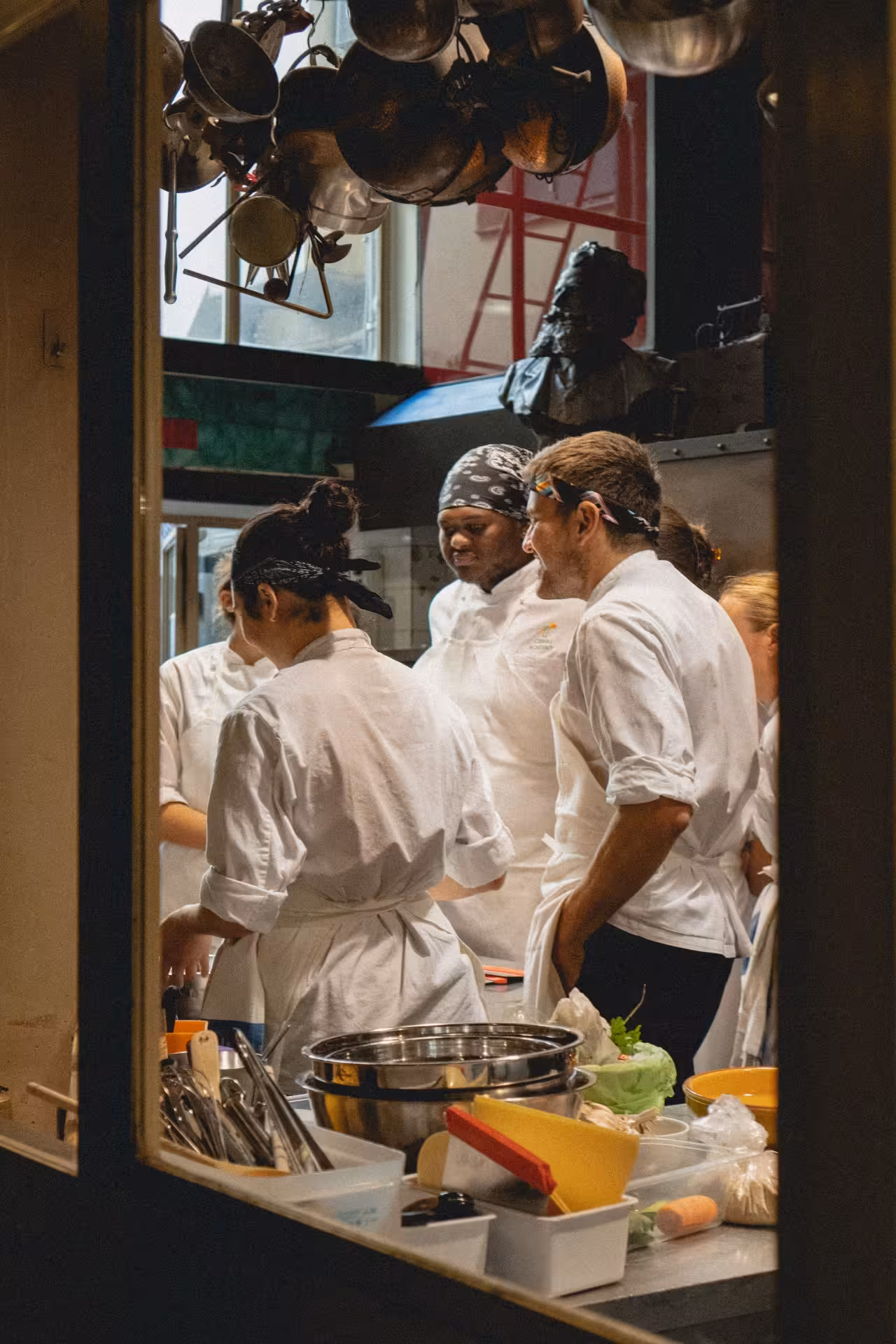 Chefs at Teatro del Sale in Florence prepare dinner in an open kitchen for the dining and show experience