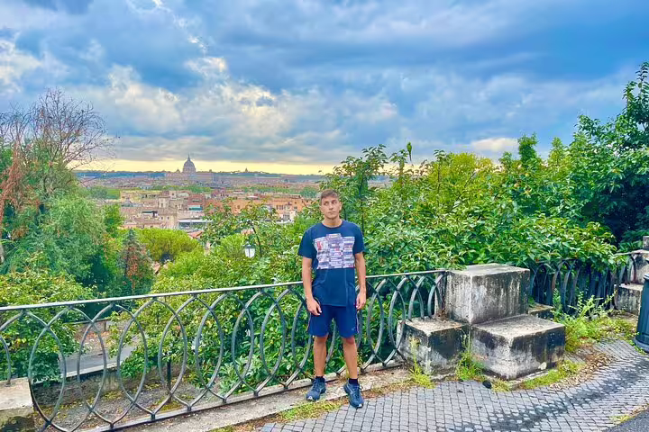 Teen on viewpoint terrace overlooking Rome skyline and St Peter’s Basilica during kid-friendly private city tour