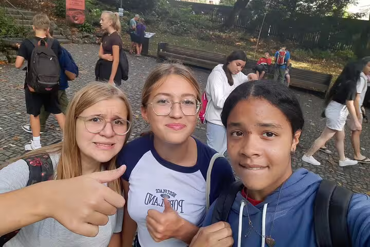 Teens taking a selfie during a Lucerne self-guided scavenger hunt tour, exploring city sights and landmarks