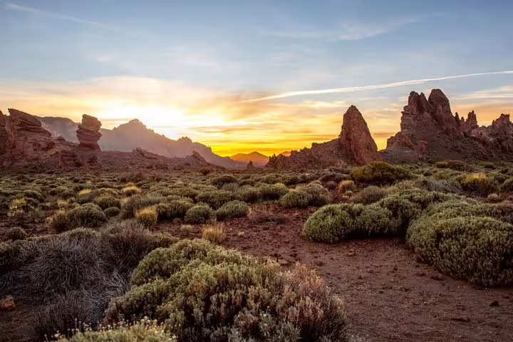 Stunning sunset over rugged landscape and unique rock formations in Teide National Park.