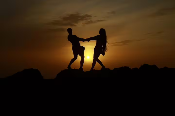 Silhouette of a couple enjoying a romantic sunset on a Teide quad trip adventure.
