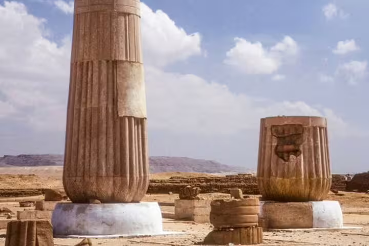 Ancient columns and stone ruins at Tel El Amarna, El Minya desert landscape on a private 2-day tour from Cairo