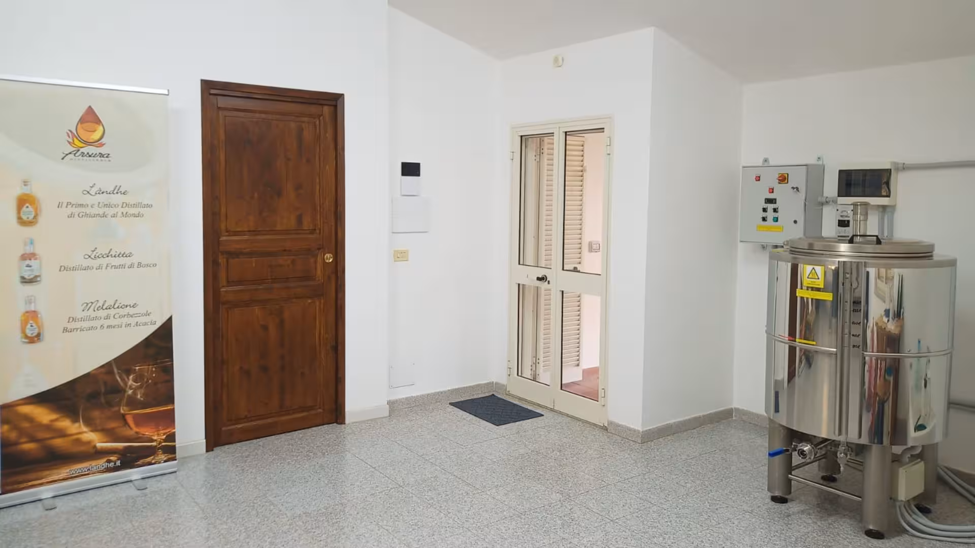 Modern distillation workshop showcasing equipment and products at Tempio Pausania distillates workshop tour.