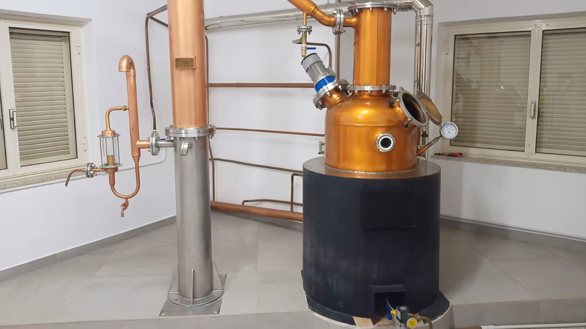 Traditional copper and steel distillation equipment inside the Tempio Pausania distillates workshop tour.