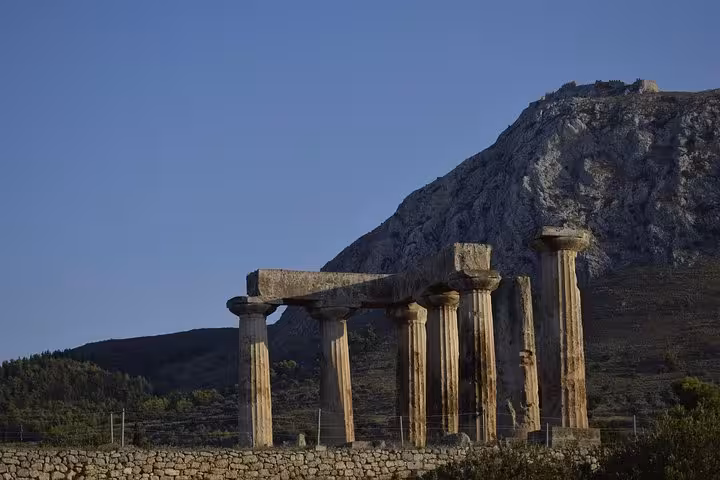 Temple of Apollo columns at sunset in Ancient Corinth near Corinth Canal, Athens day tour with wine tasting
