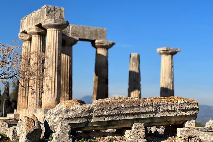 Close-up of Temple of Apollo columns in Ancient Corinth, faith and history tour in Greece with wine and oil tasting
