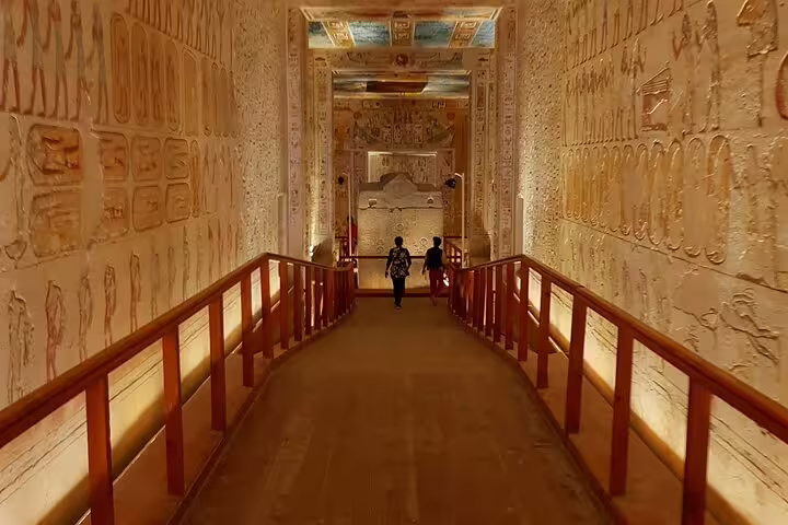Illuminated temple corridor with hieroglyphs on Nile tour, exploring ancient Egypt tomb passageways