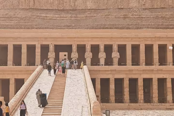 Tourists explore the ancient Temple of Hatshepsut on the Luxor West Bank, a highlight of private day tours in Egypt.