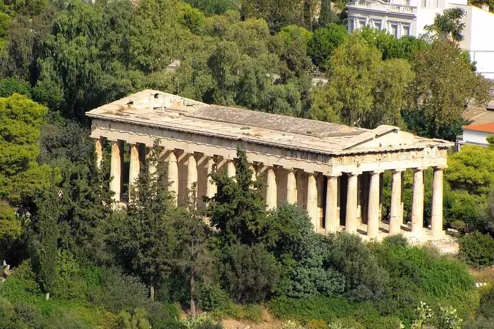 Ancient Temple of Hephaestus surrounded by lush greenery in Athens, highlighting classical Greek architecture.