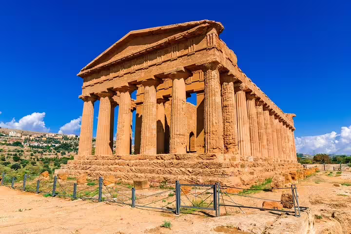 Ancient Temple of Concordia in the Valley of the Temples, Agrigento, Sicily, glowing under a clear blue Mediterranean sky