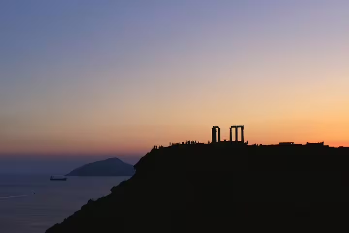 Sunset silhouette of the Temple of Poseidon at Cape Sounion, small-group half-day tour from Athens