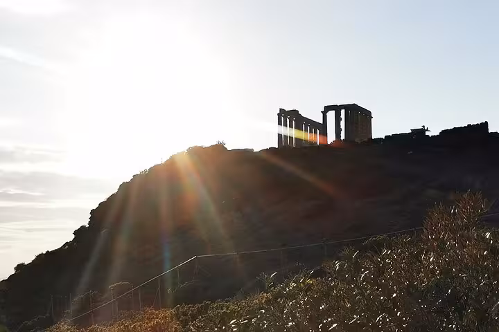 Temple of Poseidon at Cape Sounio silhouetted at sunset on a luxury private Athenian Riviera tour