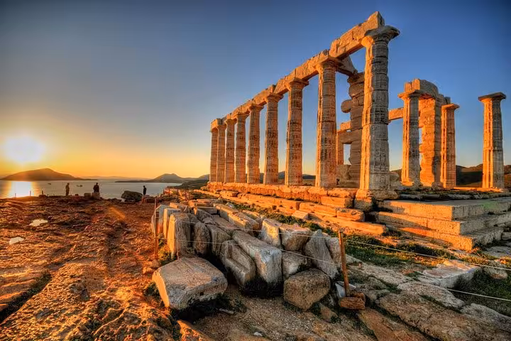 Temple of Poseidon at Cape Sounion glowing at sunset on a luxury private Athenian Riviera tour