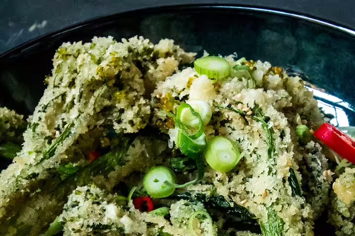 Crispy tempura vegetables garnished with fresh scallions and chili, perfect for pairing with natural organic wines.