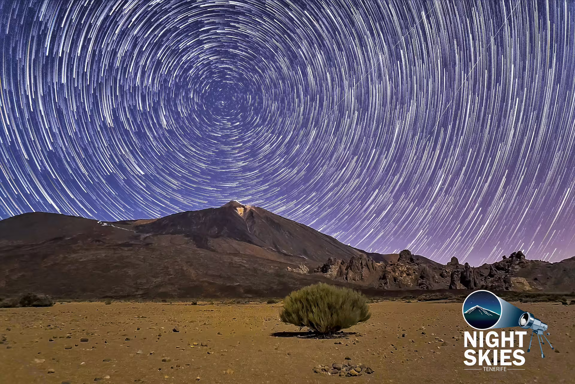 Star trails over Mount Teide in Tenerife, showcasing a stunning night sky ideal for a self-drive stargazing adventure.