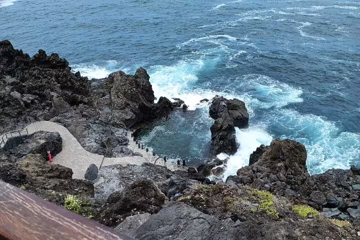 Rocky coastal path with waves crashing against the shore on a private tour of Tenerife's north coast.