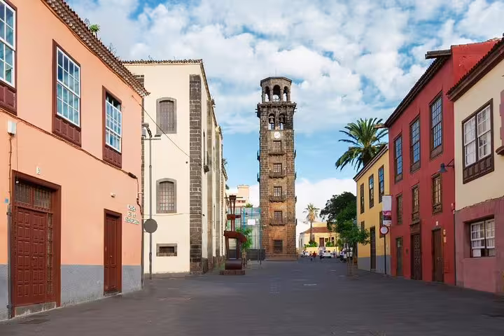 Charming street in Tenerife with historic bell tower, perfect for exploring on a 6-hour private tour.