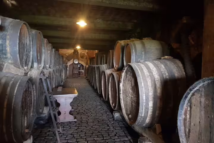 Explore the rustic charm of a Tenerife wine cellar with large oak barrels on the Enogastronomic Tour.