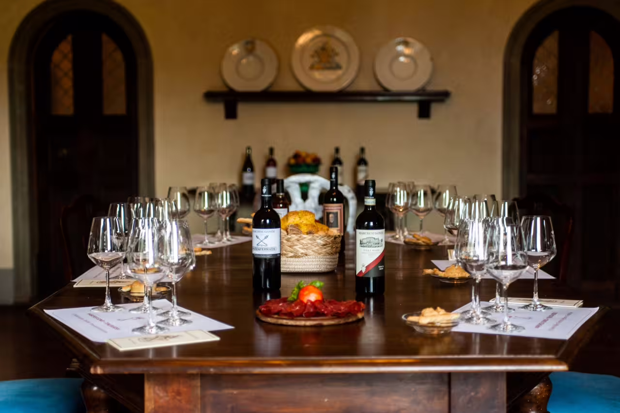 Tenuta Bossi wine tasting table set with glasses, bread and snacks for sampling 3 exquisite Tuscan wines