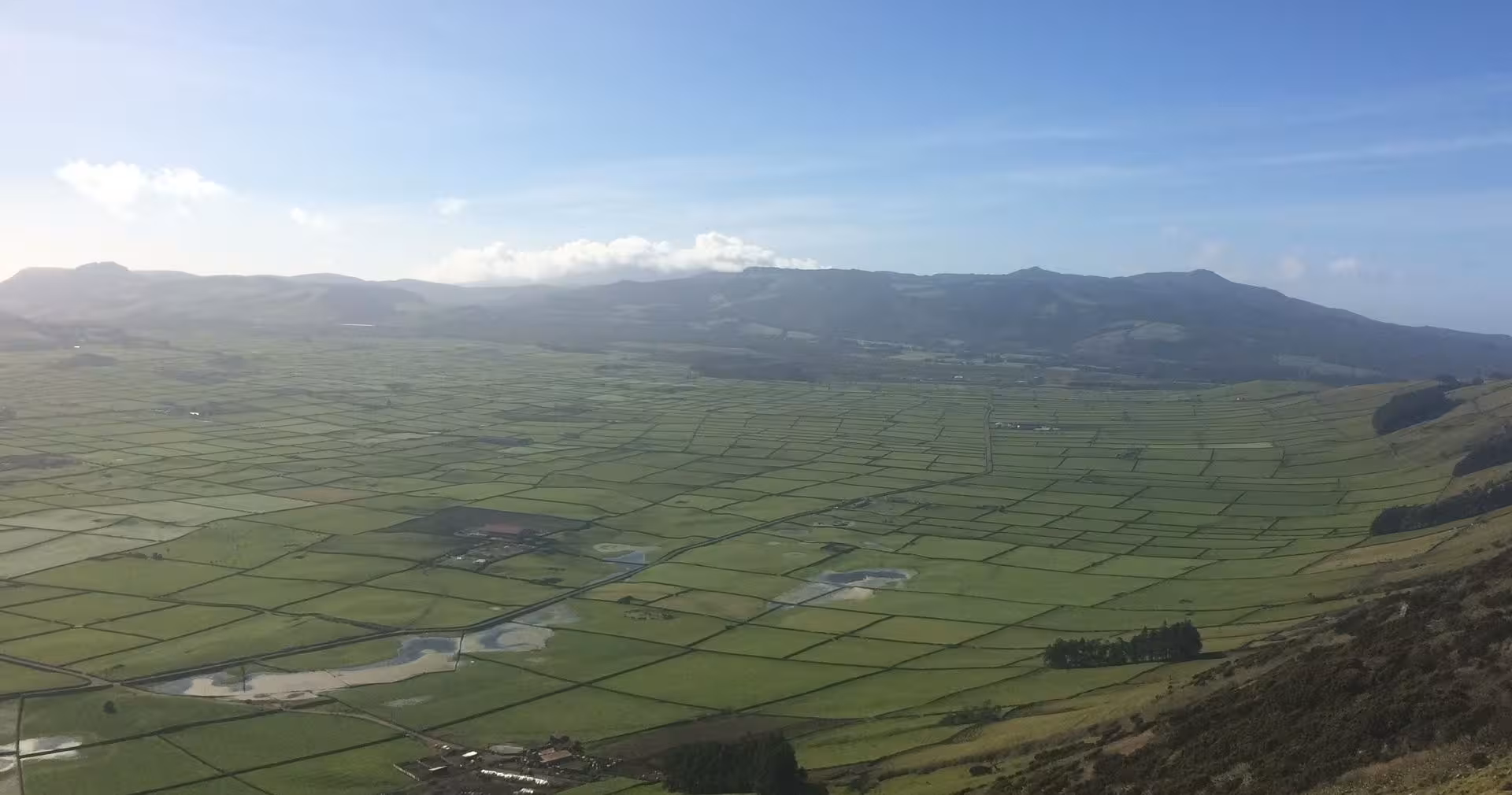 Panoramic view over Terceira’s green patchwork fields from a scenic viewpoint on the east van tour