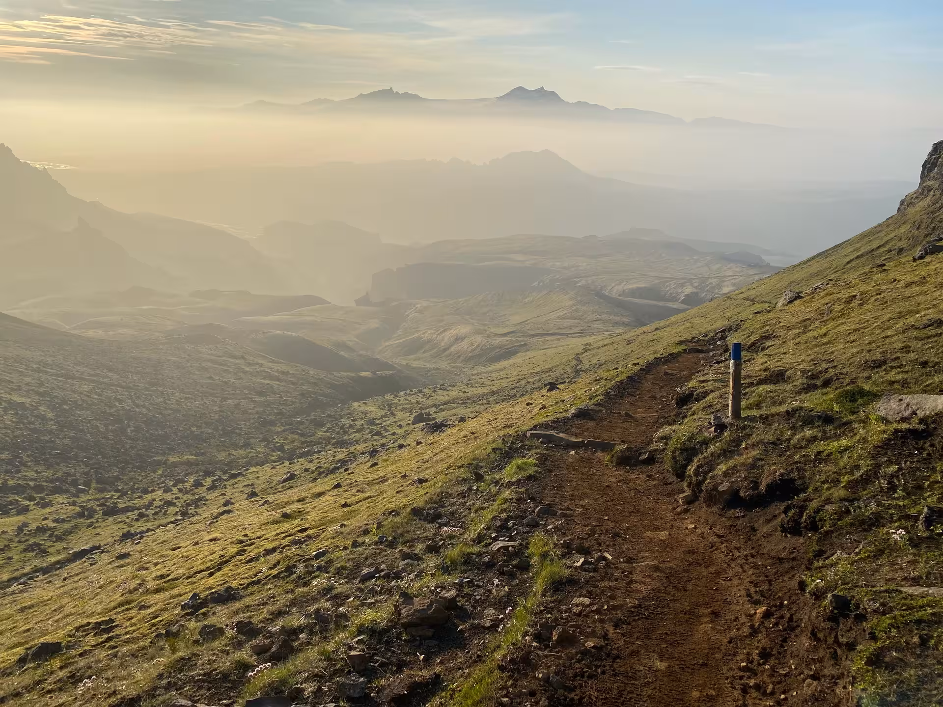 Sunset hiking trail above Vík with misty mountains, a hidden gem viewpoint on the Thakgil tour