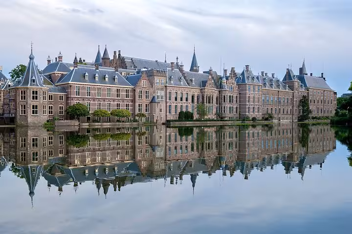 The Hague Binnenhof complex reflected in the Hofvijver lake on a Famous Holland day tour from Amsterdam