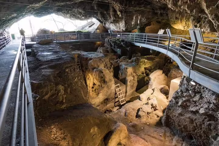 Inside view of Theopetra Cave showcasing ancient archaeological excavations and rock formations.