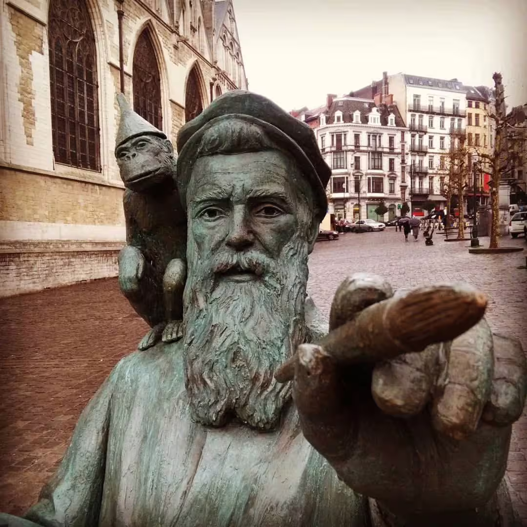 Statue of Thijl Uilenspiegel with monkey in Brussels, highlighting cultural charm on a private walking tour of the city.