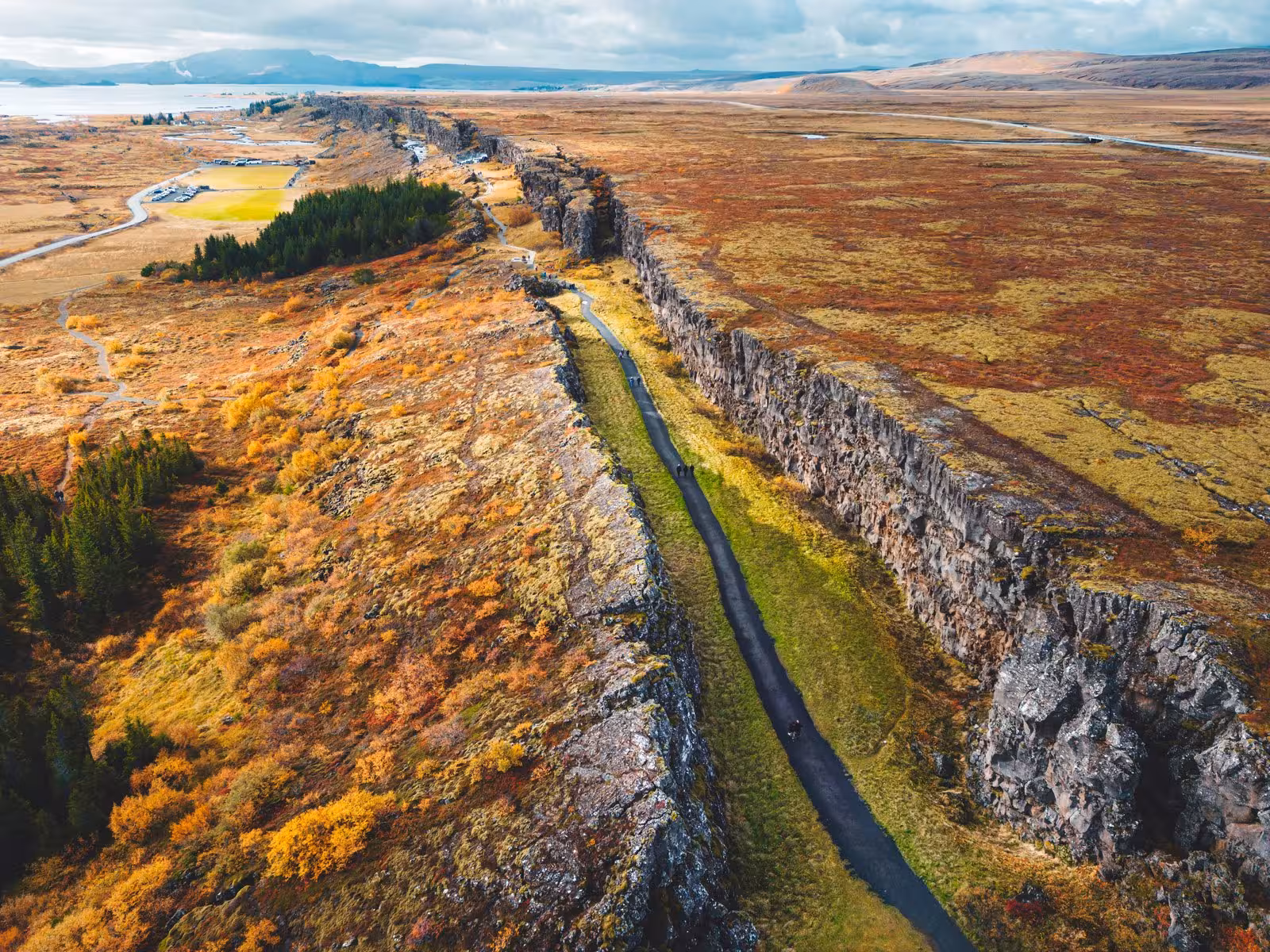 Aerial view of Þingvellir National Park's dramatic rift valley with autumn foliage near Reykjavík, Iceland.