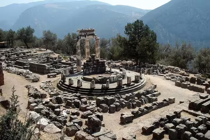Tholos of Athena Pronaia ruins in Delphi with mountain views, private day tour from Athens to Delphi