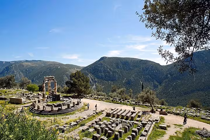 Tholos of Athena Pronaia at Delphi ruins with mountain views, private day trip from Athens Greece