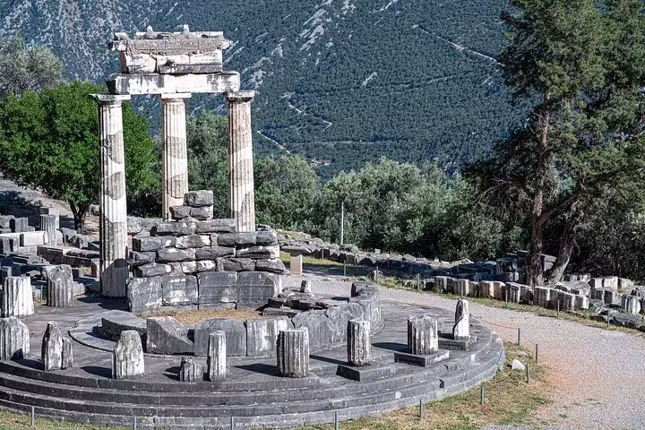 Discover the iconic Tholos of Delphi amid breathtaking mountain scenery on a classical private tour from Athens.